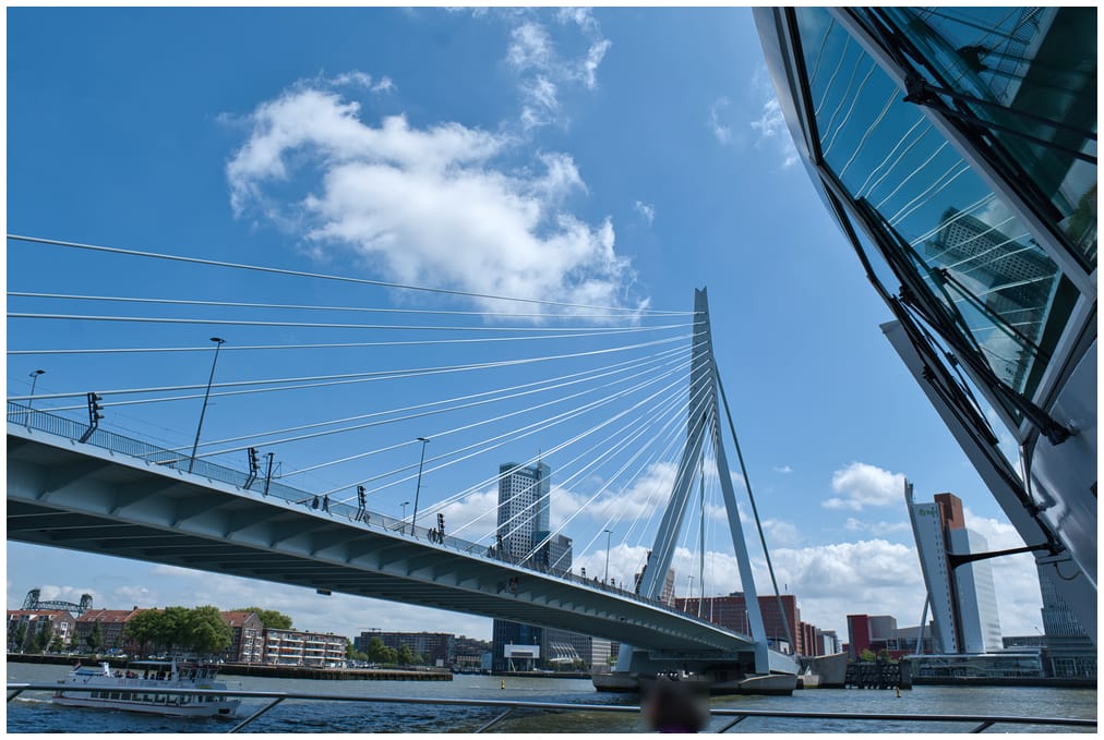 A suspension bridge reflected in the windows of the ships bridge on a sunny day.